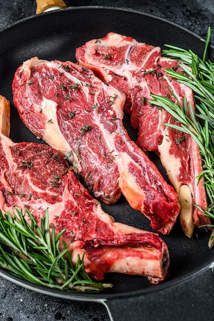 Beef raw meat steaks in a pan