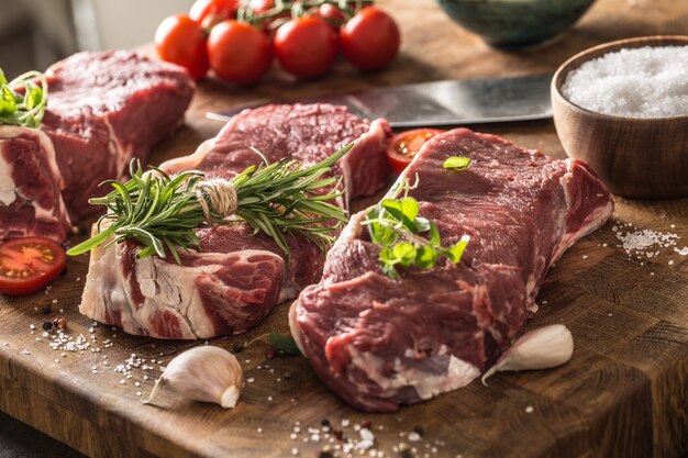 Beef ribe eye steaks with rosemar oregano and tomatoes.