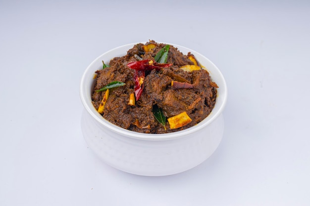 Beef roast masala or curry homemade recipe arranged in white bowl  with white background