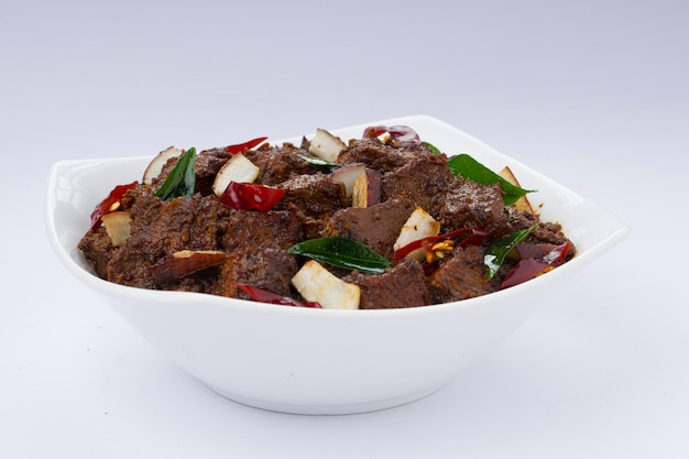 Beef roast masala or curry homemade recipe arranged in white bowl with white background