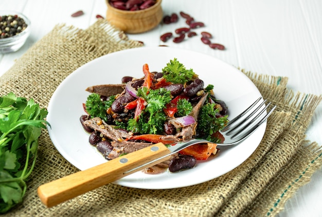 Beef salad with beans and sweet pepper Salad Tbilisi traditional Georgian cuisine Closeup