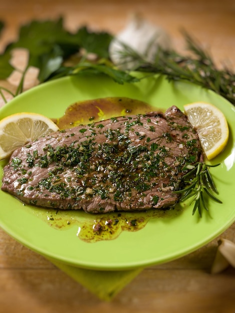 Beef steack with garlic and mixed herbs selective focus