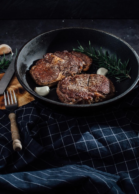 beef steak on black table background