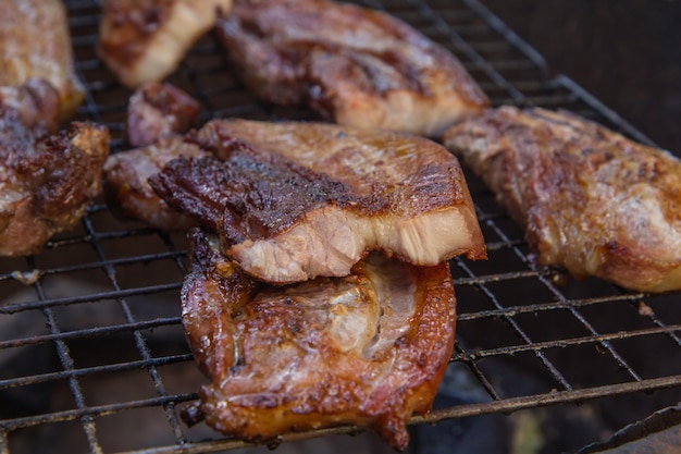 Beef steak on the grill with flames.