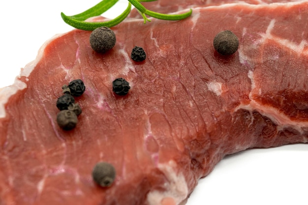 Beef steak view of fresh beef isolated on white with rosemary black pepper