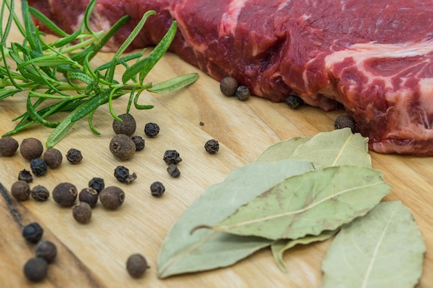 Beef steak view of fresh beef on a wooden board with rosemary black pepper lavatory leaf