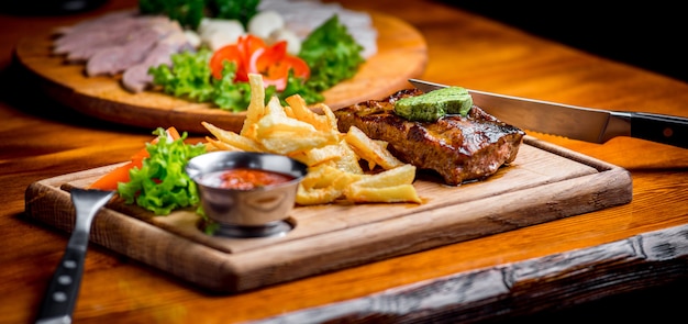 Beef steak with pepper sauce and Grilled vegetables on cutting board