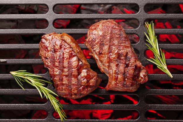 Beef steaks cooking on grill