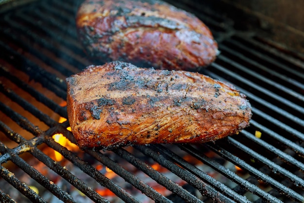 Beef steaks on the grill with flames steak roasted on fire