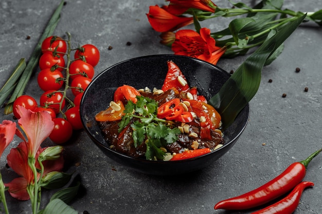 Beef wok. Traditional chinese mongolian beef stir fry in chinese cast iron wok with cooking chopsticks