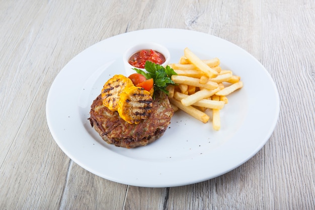 beefsteak with french fries corn and sauce