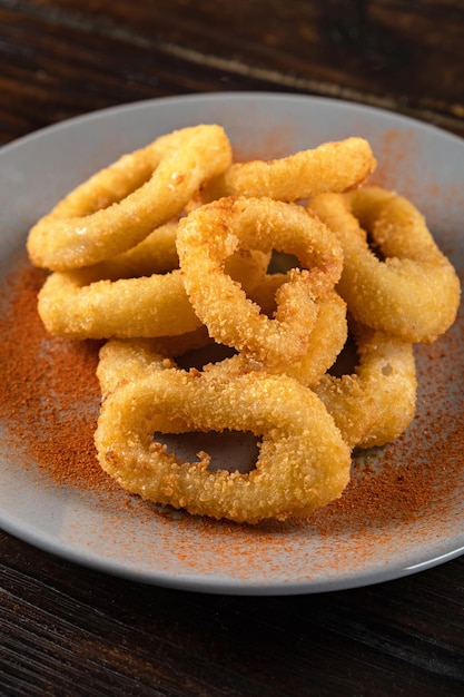 Beer appetizer from a squid ring in a plate on a wooden table