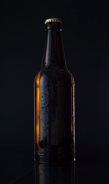 Beer botle on black background bottle of beer on a black background. Advertising photo