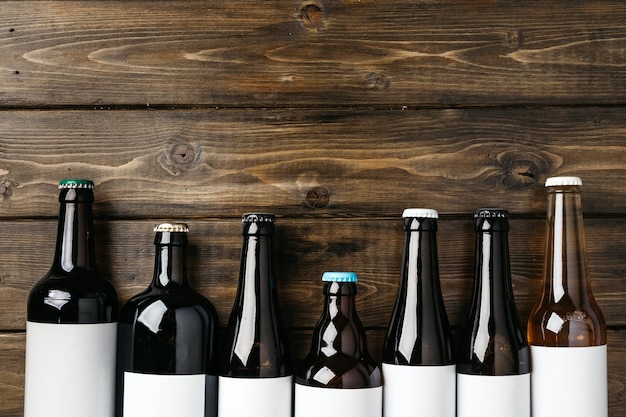 Beer bottle on a brown wooden table flat lay background with a copy space