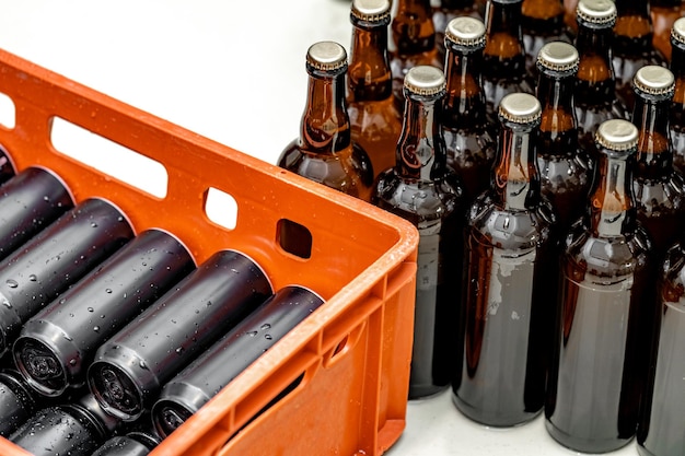 Photo beer bottles and beverage cans in the brewery warehouse