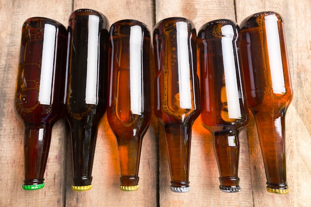 Beer bottles on a wooden table .