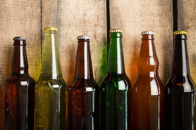 Beer bottles on a wooden table .