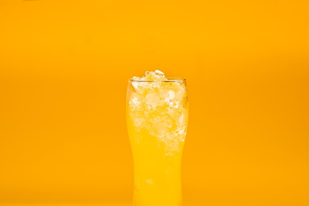 Beer cocktail yellow in a beer glass on a yellow background