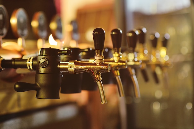 Beer faucet close-up against a bar in the pub