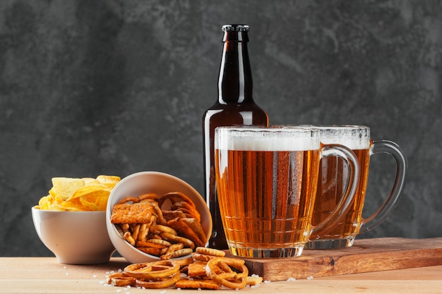 Beer glass with bretzel and dried sausages snacks 