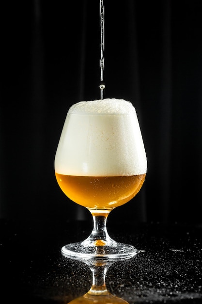 Beer pouring beer into glass with thick foam