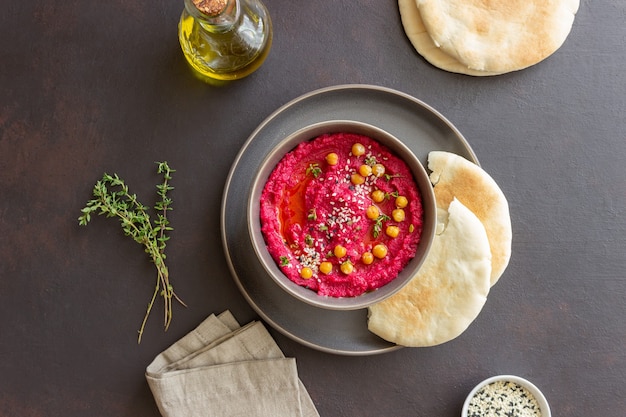 Beet hummus in a gray bowl. Healthy eating. Vegetarian food.