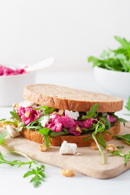 Beetroot and feta cheese sandwich with walnuts and rocket