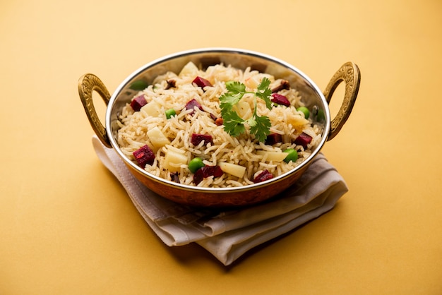 Beetroot Rice or pulao or pulav served in a bowl or karahi, selective focus. Indian food