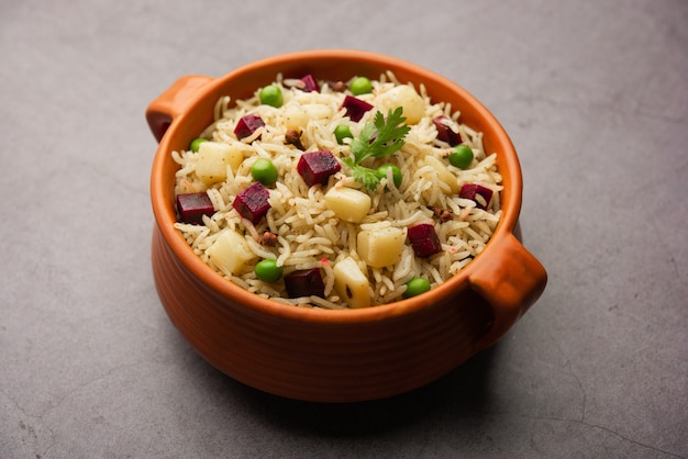 Beetroot Rice or pulao or pulav served in a bowl or karahi, selective focus. Indian food