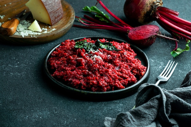 Beetroot risotto with hard cheese, caramelized leaves