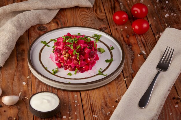 Beetroot salad, Russian cuisine, wooden background