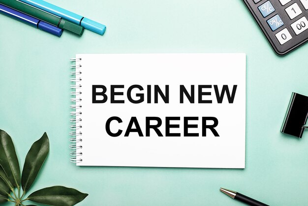 BEGIN NEW CAREER is written on a white sheet on a blue surface near the stationery and the Scheffler sheet