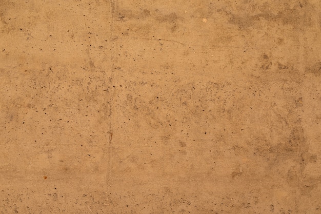 A beige-brown concrete wall, interior texture