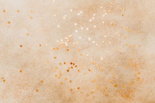 Beige stone background with golden stars on in