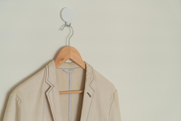 Beige suit hanging with wood hanger