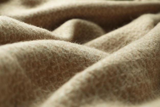 Beige woolen fabric with geometrical pattern closeup