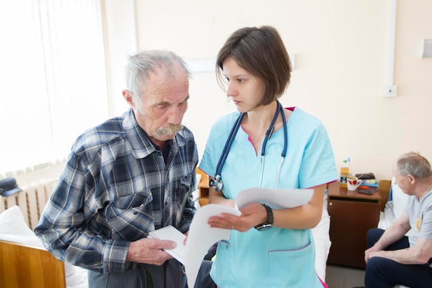 Belarus city of Gomel May 31 2021 Hospital The therapist talks with an elderly patient Caring doctor cardiologist talks with an old man