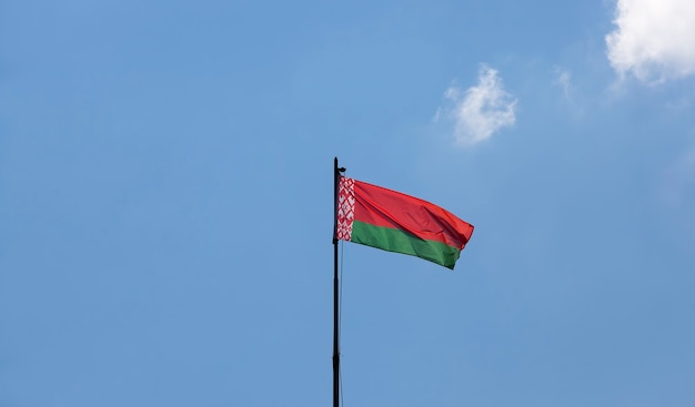 Belarusian state flag on a blue sky