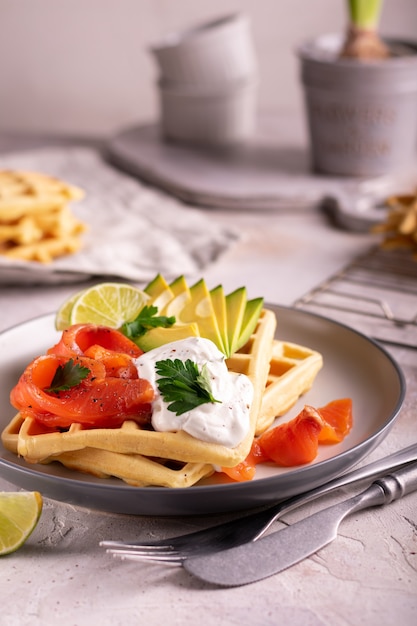 Belgian waffles with avocado and salmon for breakfast