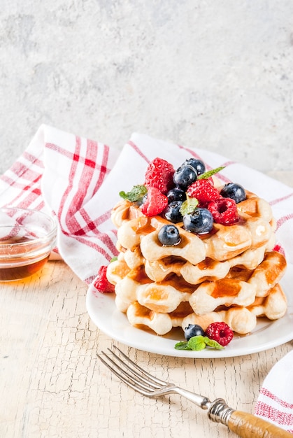 Belgian waffles with raspberries, blueberries and syrup