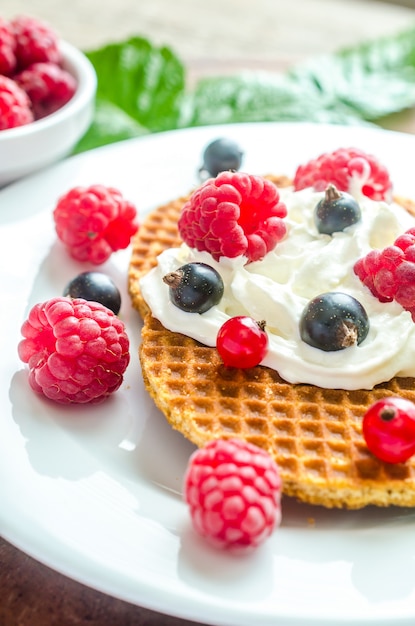 Belgian waffles with whipped cream and fresh berries