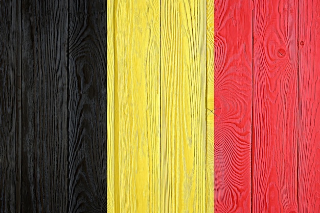 Belgium flag painted on old wood plank background Brushed natural light knotted wooden board texture Wooden texture background flag of Belgium