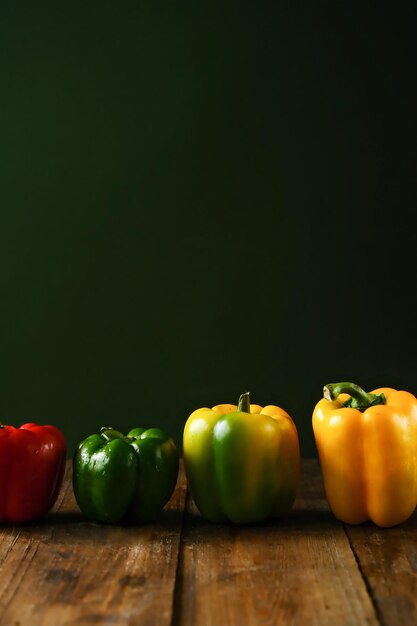 Bell pepper on a wooden table Bell peppers of different colors Yellow red green bell pepper Pepper