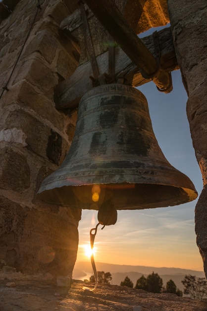 A bell tower close up at sunset