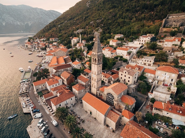 Bell tower among the old houses in perast coast montenegro drone