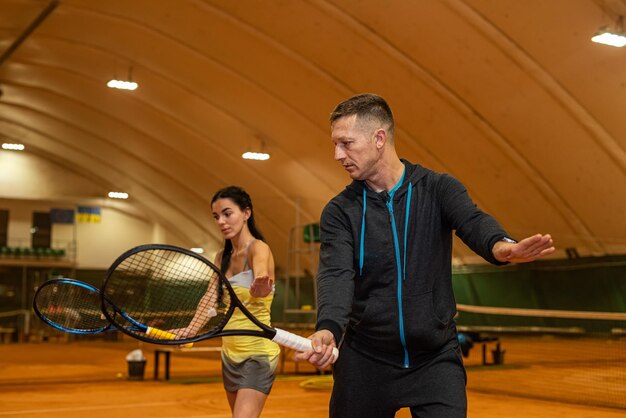 Beloved wife smiles before playing tennis on weekend with handsome husband Loving wife smiles family hobby