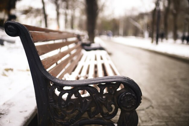 bench in a cold winter park snow