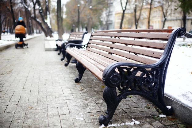 bench in a cold winter park snow