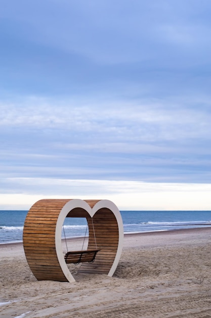 bench in the form of a heart on the beach of the Baltic Sea in Yantarny