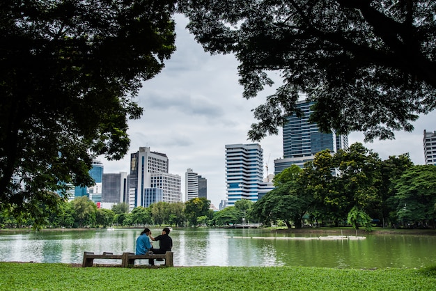 Bench near tree in public park with couple